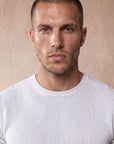 Man in white knit t-shirt with navy trousers, Morengar menswear