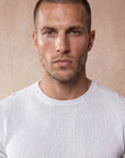Man in white knit t-shirt with navy trousers, Morengar menswear