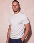 Man in white knit t-shirt with hand on hip, Morengar menswear