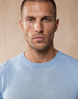 Man wearing light blue Morengar knit t-shirt, close-up