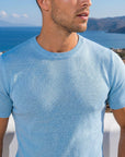 Man in light blue knit t-shirt by the sea, Morengar summer look