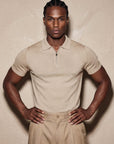 Man in beige knit polo with hand on hip, Morengar menswear