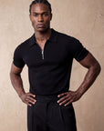 Man in black knit polo and black trousers, Morengar menswear
