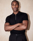 Man in black knit polo with arms crossed, Morengar menswear