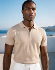 Man wearing beige knit polo by the sea, Morengar summer menswear