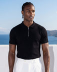 Man wearing black knit polo by the sea, Morengar menswear