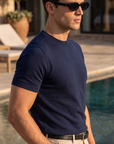→ "Man wearing navy knit t-shirt by the pool, Morengar summer menswear