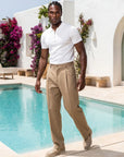 Man wearing white knit polo by the pool, Morengar summer menswear