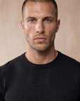 Man wearing black Morengar knit t-shirt, close-up