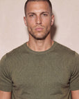 Man wearing olive green Morengar knit t-shirt, close-up
