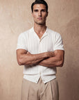 Man in white vertical texture knit shirt with arms crossed, Morengar menswear