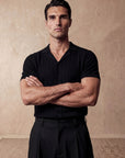 Man in black vertical texture knit shirt with arms crossed, Morengar menswear