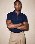 Man in navy knit polo with arms crossed, Morengar menswear