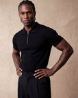 Man in black knit polo with hand on hip, Morengar menswear