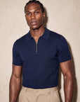 Man in navy knit polo with beige trousers, Morengar menswear