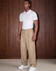 White knit polo styled against wood wall, Morengar menswear