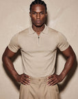 Man in beige knit polo with hand on hip, Morengar menswear