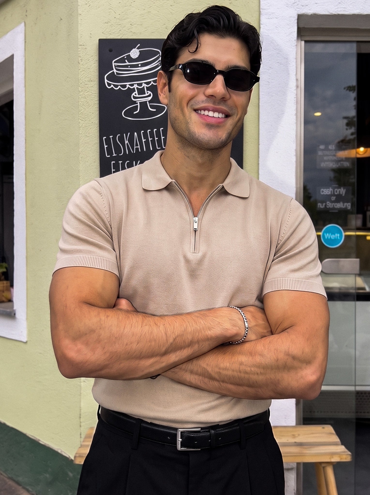 Man in beige knit polo with sunglasses, arms crossed, Morengar menswear