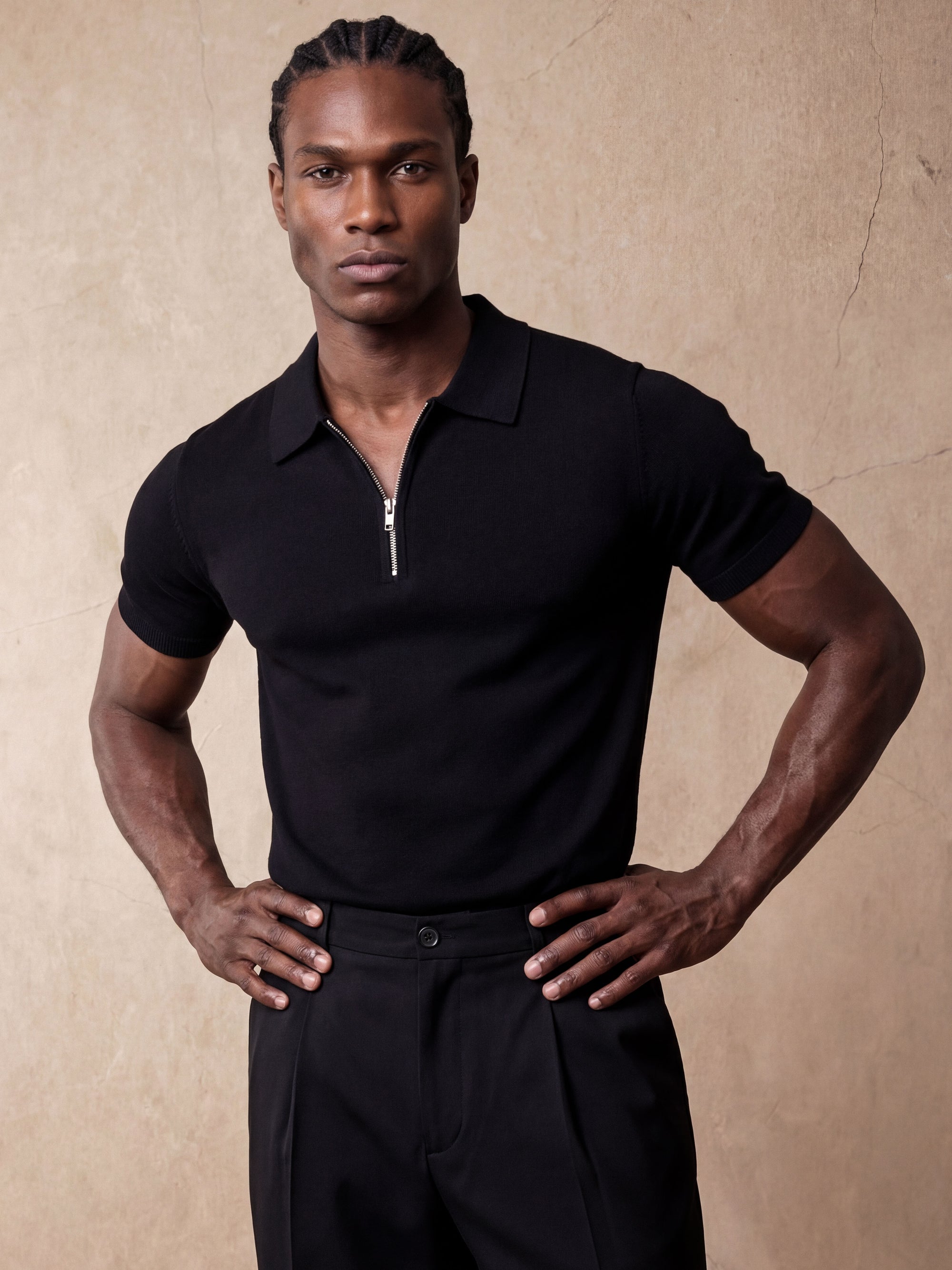 Man in black knit polo and black trousers, Morengar menswear