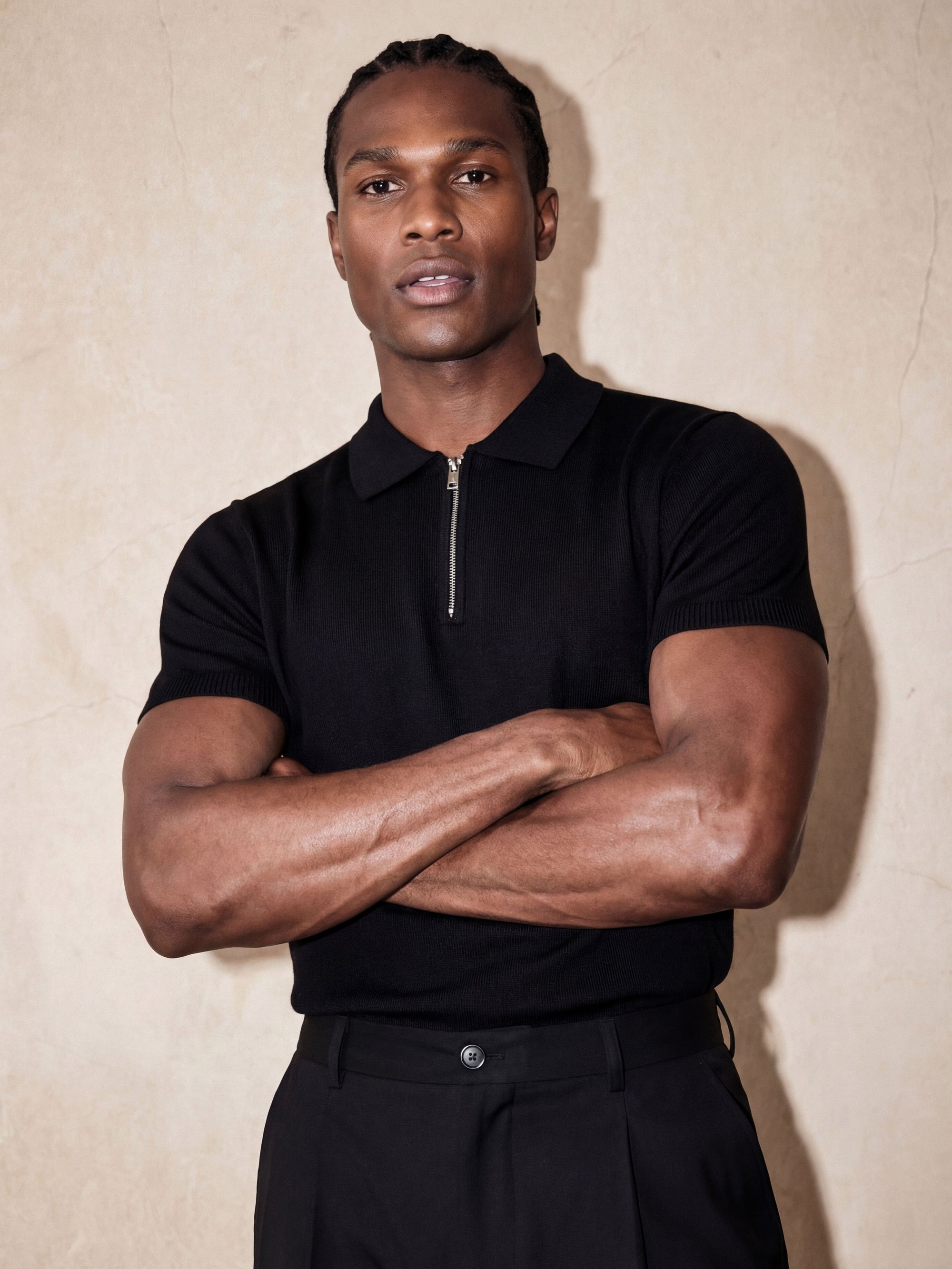Man in black knit polo with arms crossed, Morengar menswear