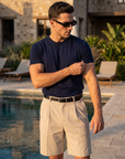 Man in navy knit t-shirt with beige shorts, summer style