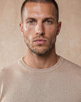 Man wearing beige Morengar knit t-shirt, close-up