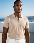 Man wearing beige knit polo by the sea, Morengar summer menswear