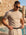 Man wearing beige knit t-shirt by the pool, Morengar summer menswear