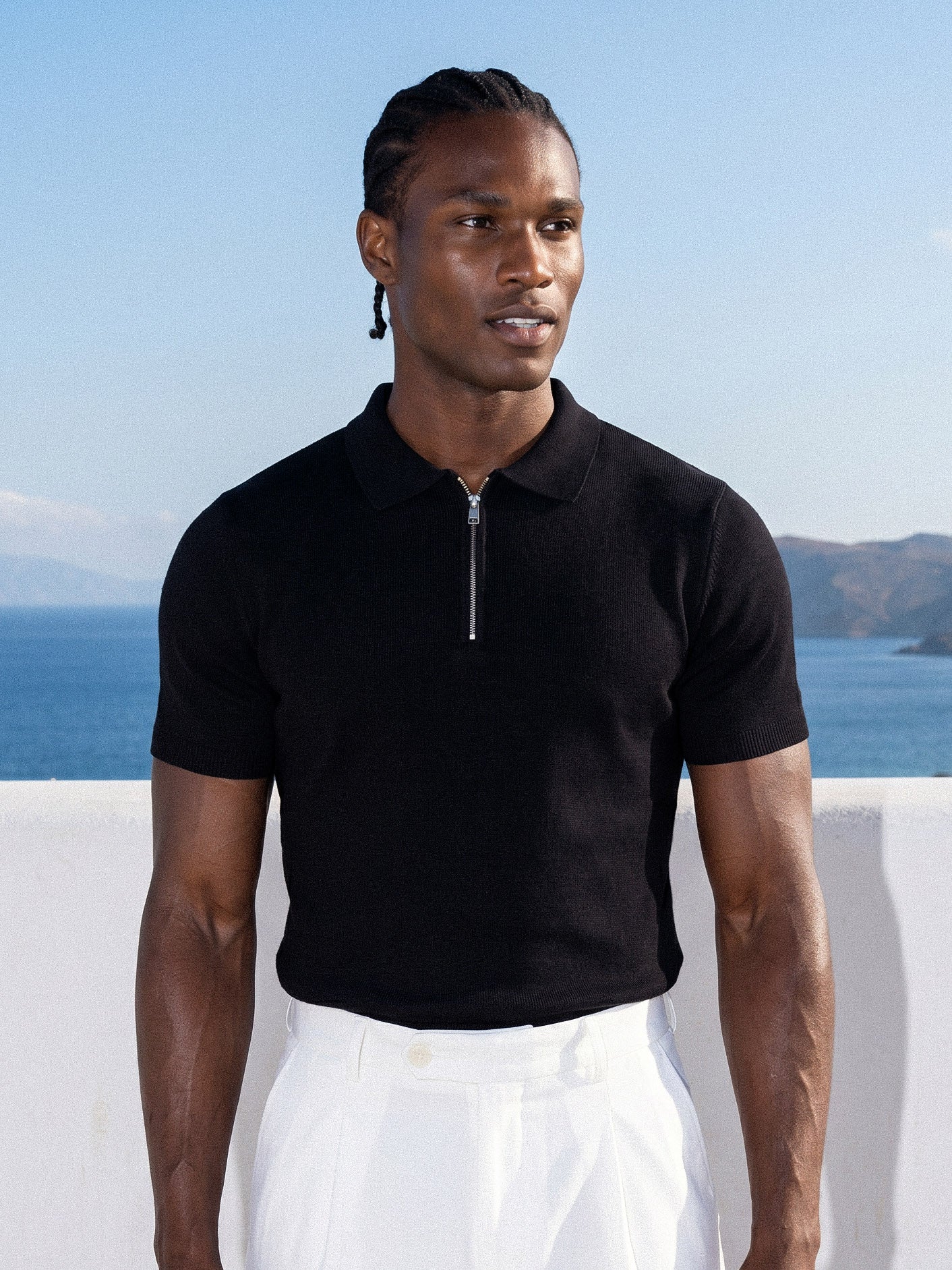 Man wearing black knit polo by the sea, Morengar menswear