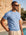 → "Man wearing light blue knit t-shirt by the pool, Morengar summer menswear
