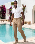 Man wearing white knit polo by the pool, Morengar summer menswear