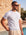 Man wearing white knit t-shirt by the pool, Morengar summer menswear