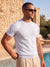 Man wearing white knit t-shirt by the pool, Morengar summer menswear