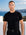 Man wearing black knit t-shirt by the sea, Morengar summer menswear