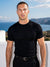 Man wearing black knit t-shirt by the sea, Morengar summer menswear